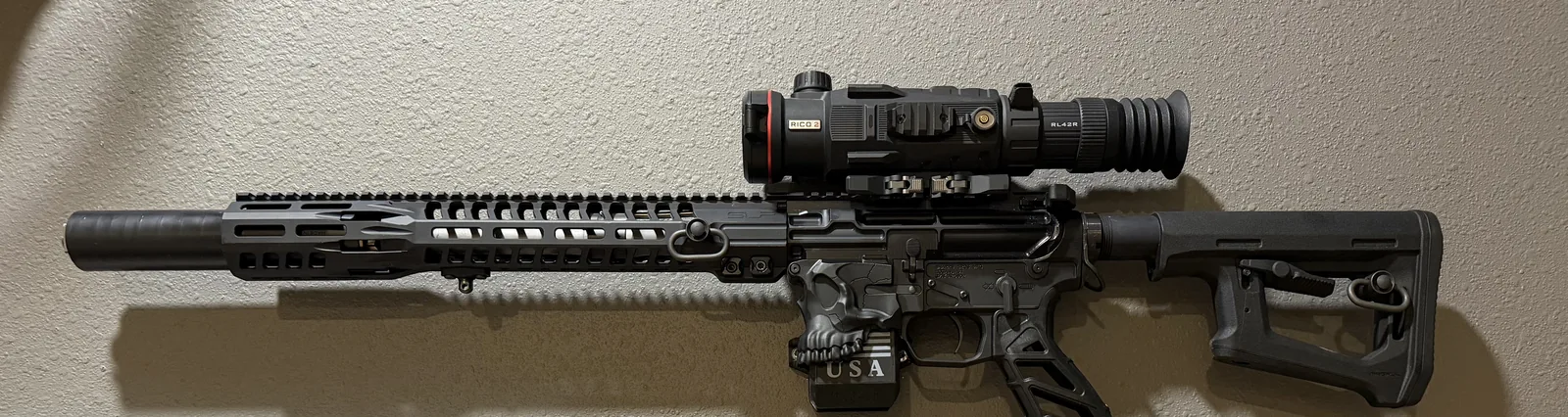 Black AR with RICO thermal optic, skull-engraved lower and suppressor